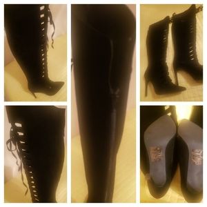 Black front lace suede boots with 5 or 6 inch heels.